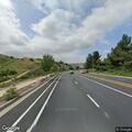 Pedestrian walking on westbound road shoulder