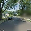 Car partially blocking driveway on Henry Street