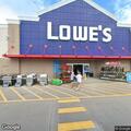 Man hiding in bushes near lumber entrance at store