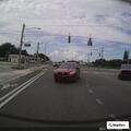 Driver runs red light and throws items at car