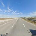 Officer checks for road hazards on highway ramp