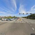 Traffic stop on white Nissan Rogue at intersection