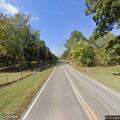 Parked minivan on wrong side of rural roadway