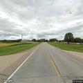 Disabled car out of gas near water tower