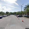 Person checking car doors in parking lot