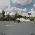 Brush fire next to auto parts store parking lot