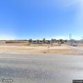Woman sitting near railroad tracks north of Natalia