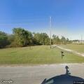 Small trash fire contained behind residence