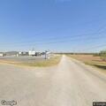 Grass fire near building in industrial area