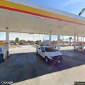 Officer assists driver refueling near traffic lane