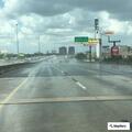 Officer checks pickup truck on freeway shoulder
