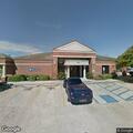 Car hits median and stops at bank parking lot