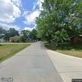 Woman speeds away in red car from residence