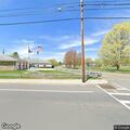 Vehicle dumping trash near vacant firehouse