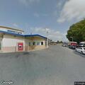 Van hits pole near gas pump on East West Highway