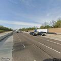 Officer checks person with suitcase on highway