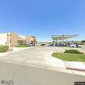 Elderly man disoriented and standing by gas pump at intersection