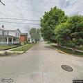 Person experiencing chest pain and difficulty breathing at street corner