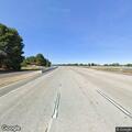 Pedestrian walking on highway shoulder in Concord
