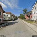 Tree leaning on power lines over roadway