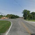 Man on bike taking wires from utility poles