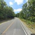 Small brush fire spreading on Water Road
