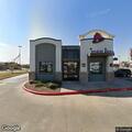 Officer checks gold GMC near Taco Bell