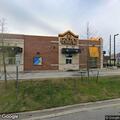 Officer checks man walking in street near Golden Chick