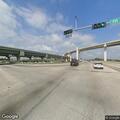 Stranded gray sedan on Eastex Freeway service road