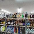 Vehicle backs into liquor store and leaves