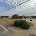 Person lying in roadway near parking lot speed bump