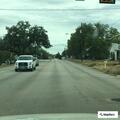 Officer checks vehicle with open door at gas station