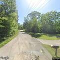 Forest officers investigate campsite with green bus