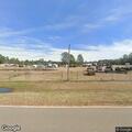 Vehicle fire at storage yard with brush fire nearby