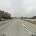 Disabled silver Honda on freeway median