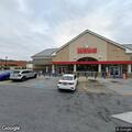 Person experiencing back pain at convenience store
