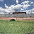 Female falls at track in front of bleachers
