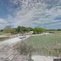 Vehicle with camper stuck in ditch blocking road