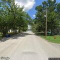 Officer follows black Nissan through town streets