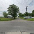 Man sitting in road flailing arms in Ashley