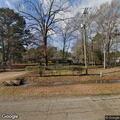 Brush fire spreading in woods behind residence