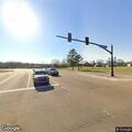 Officer checks stopped white pickup near highway