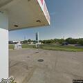 Truck on its side in gas station parking lot