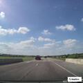 Semi-truck driving on highway with blown tire