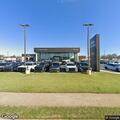 Business alarm and open door at auto dealership