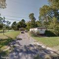 Person experiencing back pain near Meadowbrook Drive in Mineola