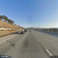 Stopped gray Tesla on highway shoulder
