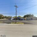 Suspicious person near business dumpsters at night