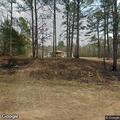 Brush fire rekindles and spreads into nearby woods