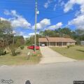Suspicious vehicle with person on car in driveway